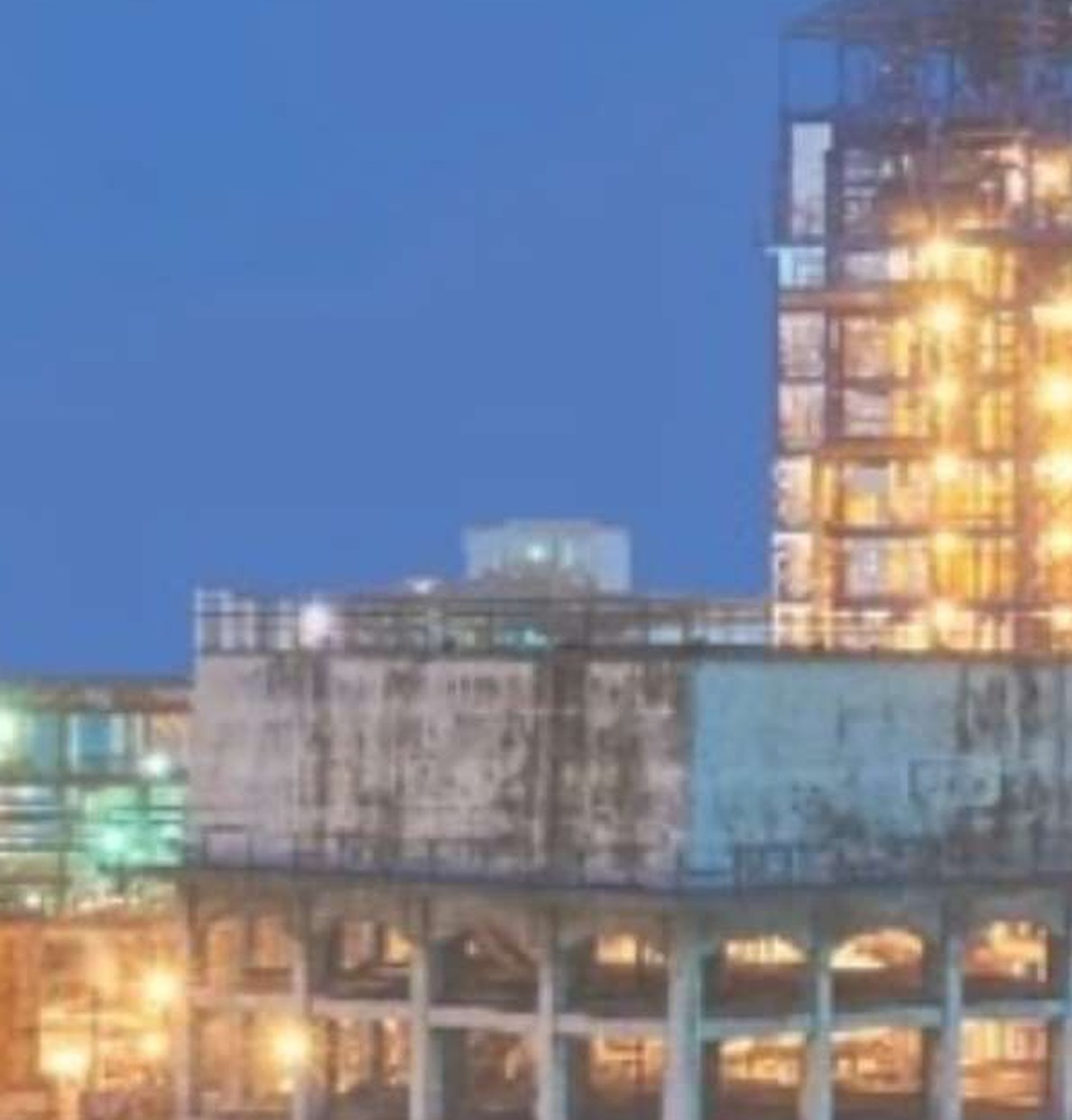 Integrated pulp and paper mill lit at dusk
